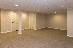 Finished basement space with waterproof wall paneling and floor system