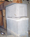 Concrete crawl space support posts in Plattsburgh that are showing signs of failure as they sink into the earth.