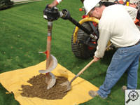 Auguring a hole in the earth for a foundation repair in Cicero