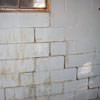 A cracked foundation wall near a window in a Geneva home