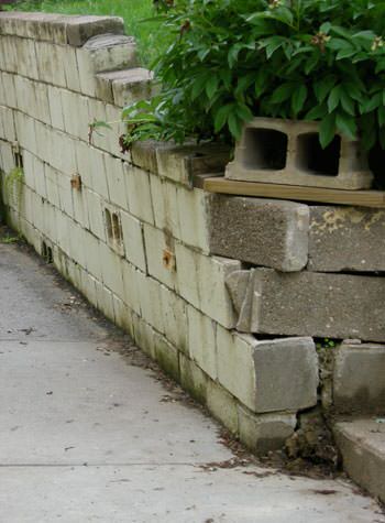 collapsing retaining wall with severe damage in Fulton
