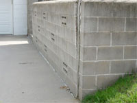 A retaining wall separating from the adjoining walls in Massena