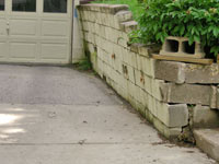 a failing retaining wall around a driveway in Syracuse