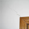 wall cracks along a doorway in a Clay home.