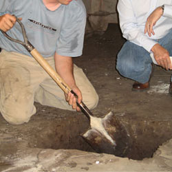 Digging a hole for the engineered fill used in a crawl space support system installation in Rochester