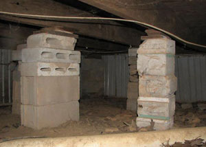 crawl space repairs done with concrete cinder blocks and wood shims in a Plattsburgh home