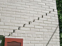 Stair-step cracks showing in a home foundation in Canandaigua