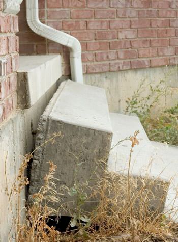 sinking outdoor concrete steps showing cracking and soil washout in Baldwinsville