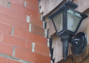A tilting chimney in Oswego showing serious foundation damage.