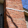 A tilting chimney on a Potsdam home with a leaning, tilting chimney that was temporarily repaired.