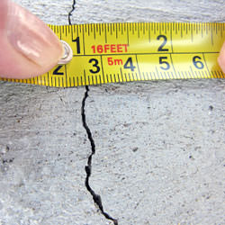 A crack in a poured concrete wall that's showing a normal crack during curing in Oneonta