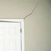 A long drywall crack beginning at the corner of a doorway in a Baldwinsville home.