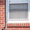 A gap in a window along the outer wall due to foundation settlement of a Endicott home.
