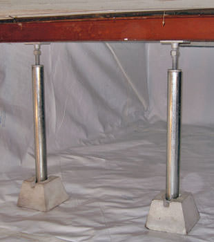 Crawl space jack posts installed in conjunction with a crawl space vapor barrier in Corning