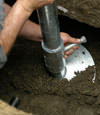 Ithaca helical pier installation nearing completion, with the blade being advanced into the foundation soils.