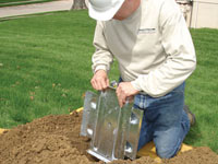 Fastening an earth anchor for a severely bowing wall in Elmira.