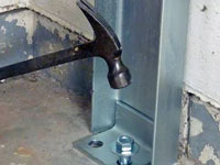 Mounting a foundation channel anchor installation to the floor in Rochester.