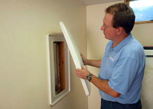 Foundation wall anchor covers installed in a finished basement with a repaired foundation wall in Corning.