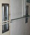 Foundation wall anchor plates installed in a basement in Utica