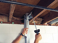 Straightening a foundation wall with the PowerBrace™ i-beam system in a Henrietta home.