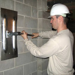 installing a wall anchor to repair an bowing foundation wall in Henrietta