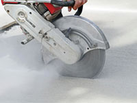 Cutting the driveway for expansion joints during street creep repair in Oswego