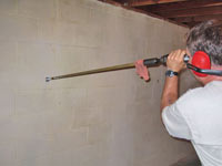 Drilling the hole in the foundation wall for street creep repairs in Canandaigua