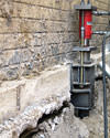 A completed installation of foundation push piers lifting a foundation in Oswego