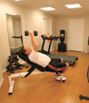 a basement gym and workout room with a wood laminate flooring, installed in Liverpool, NY